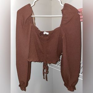 Very cute boutique top. Cropped. Ties in the front (able to make it longer)